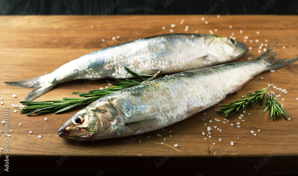Fresh fish herring with spices, lemon and salt