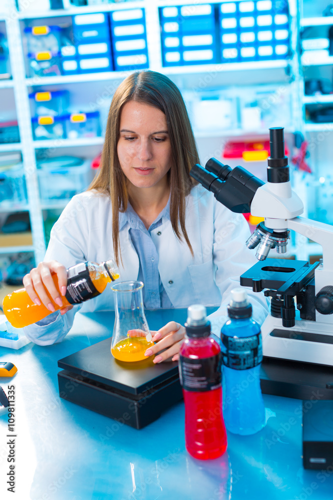 Quality control of food products. Young woman in chemical labora Quality control of food products. Young woman in chemical labora