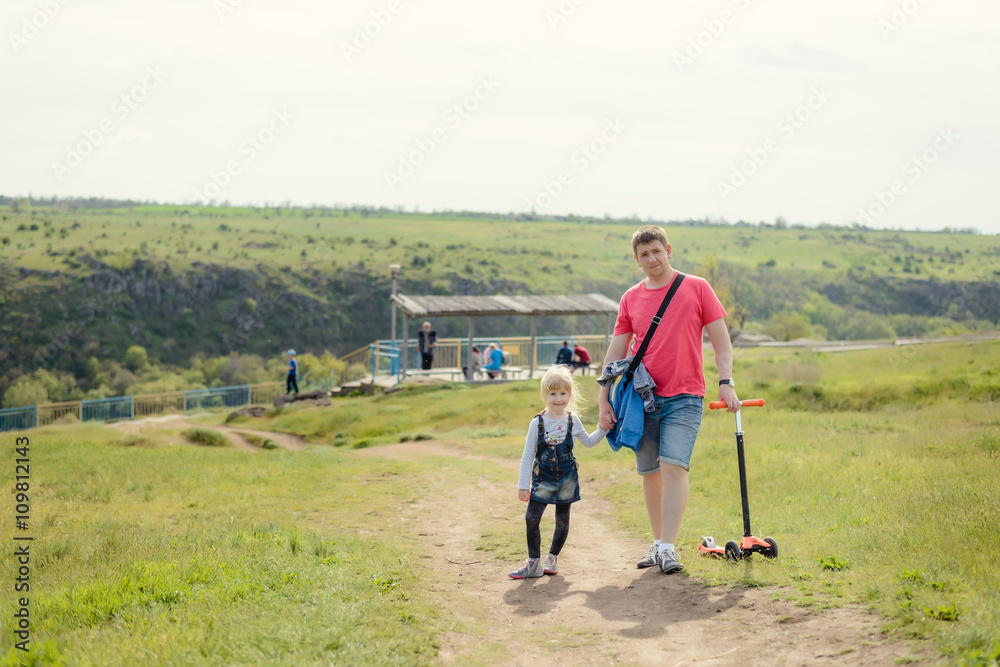 Father taking his cute young daughter for a walk