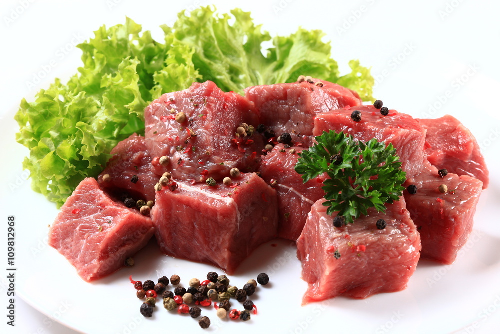 Fototapeta premium Raw Beef with green salad close up isolated on white background