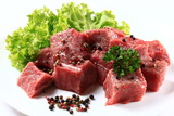 Raw Beef with green salad close up  isolated on white background