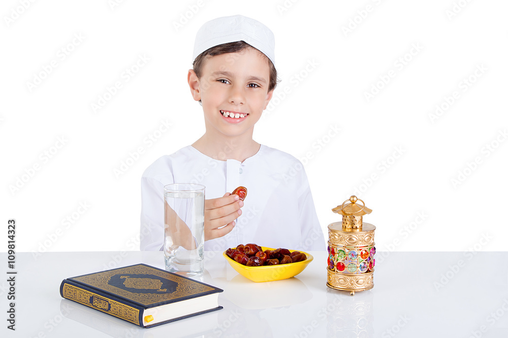 Young Muslim boy holding dates ready for brakfast in Ramadan Young Muslim boy holding dates ready for brakfast in Ramadan