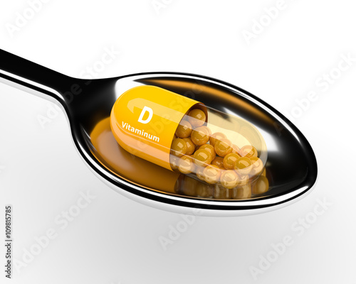 3d vitamin D pill on spoon over white photo