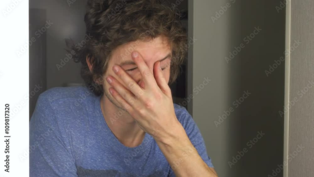 Man looks worried and frustrated, looking at himself in the mirror.
Man looks worried and frustrated, looking at himself in the mirror.