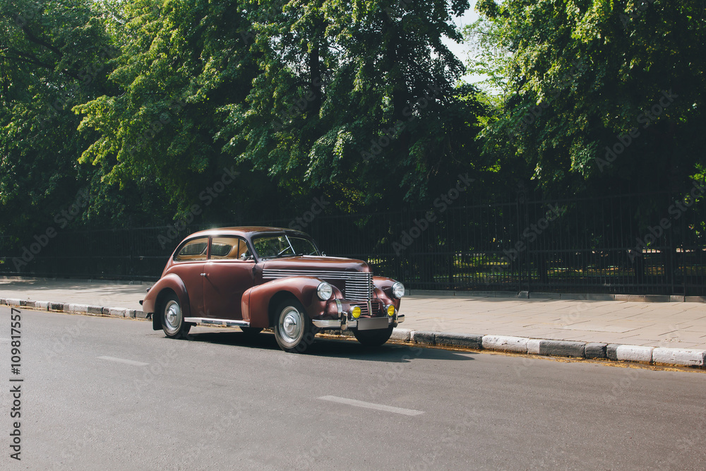 Retro car standing on road in the city Retro car standing on road in the city