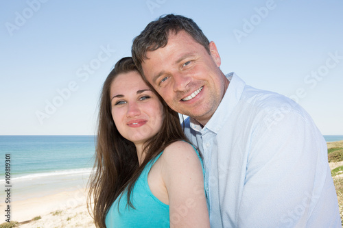 Romantic smiling cheerful couple on the beach