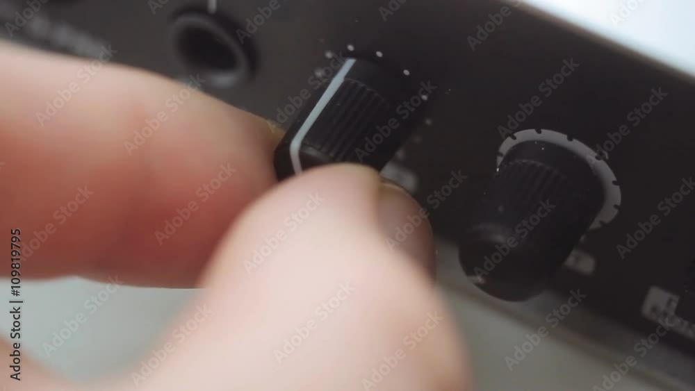 Hand adjusting the volume on an sound card Hand adjusting the volume on an sound card