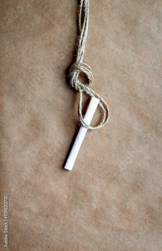 concept hangman's knot on kraft paper background with cigarette © 279photo