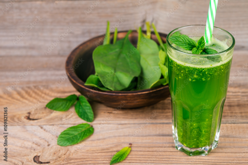 Green smoothie with spinach and mint in glass Green smoothie with spinach and mint in glass