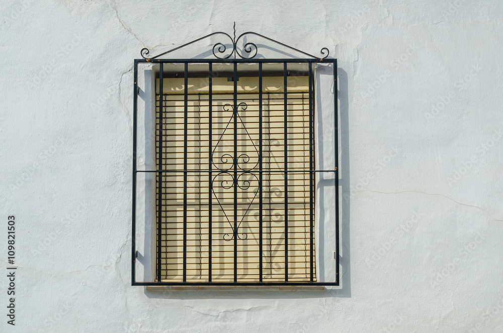 Obraz premium Shuttered window with black metal railings