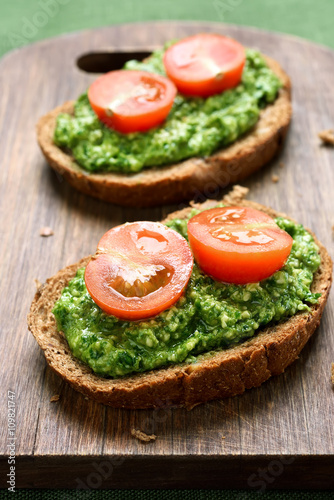 Sandwiches with pesto sauce and tomatoes