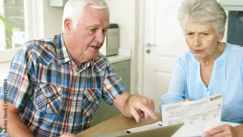 Old couple calculating theirs bills Old couple calculating theirs bills