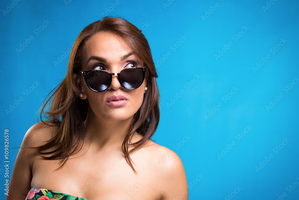 Cheerful young woman laughing with sunglasses Cheerful young woman laughing with sunglasses