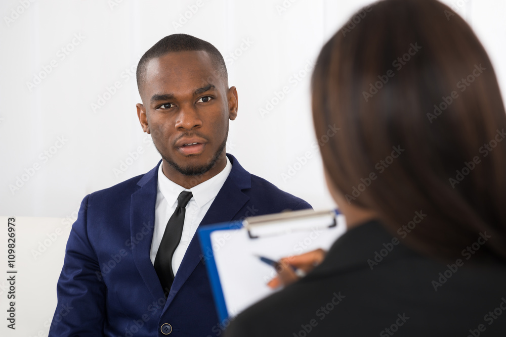 Young Man Talking With Psychologist About His Problems Young Man Talking With Psychologist About His Problems