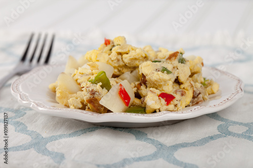 Scrambled eggs with Anaheim chilies, boiled potatoes, green peppers, and onions side view