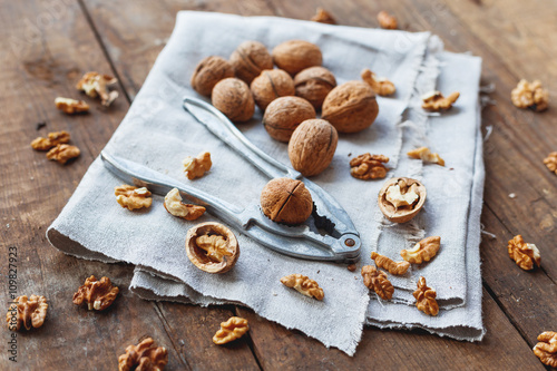 Photos Glass bowl with walnuts on rustic homespun napkin