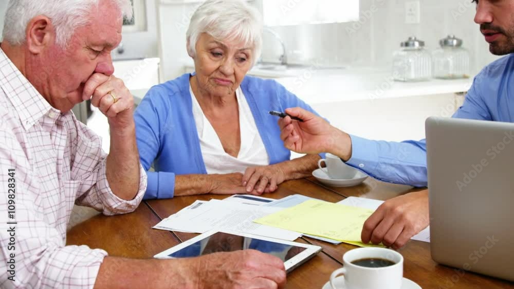 Mature couple reading some contracts Mature couple reading some contracts