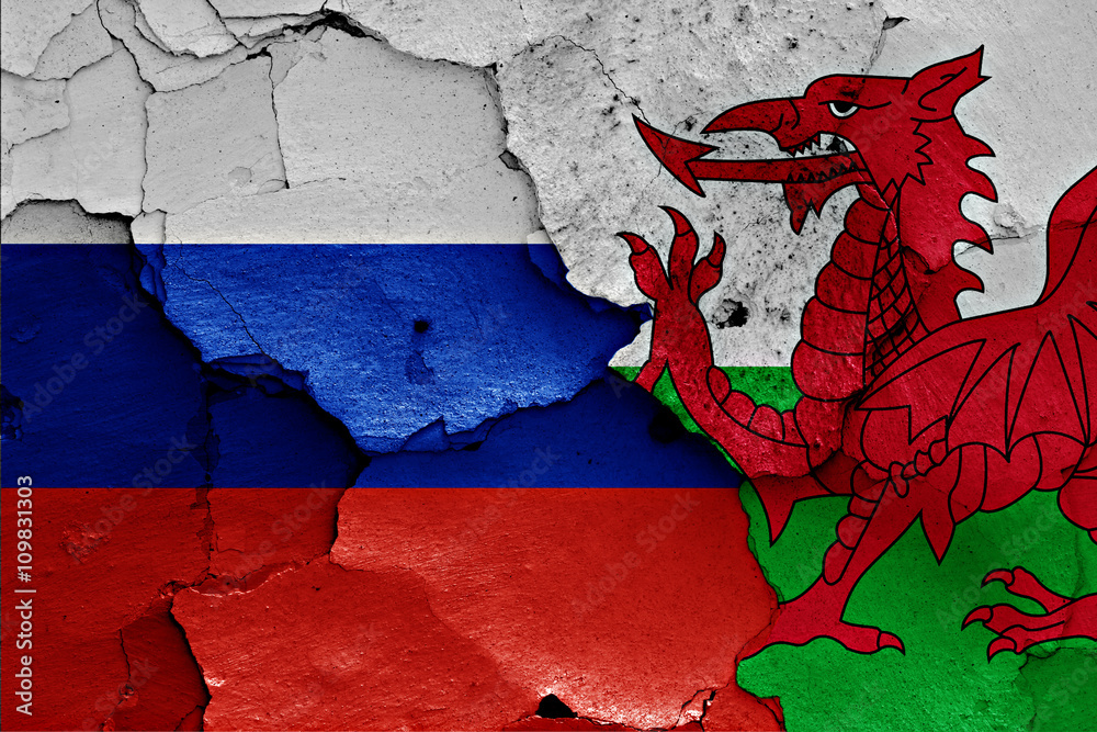flags of Russia and Wales painted on cracked wall