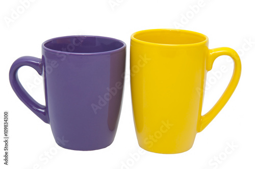 A pair of cups/Close-up of two cups of yellow and purple on a white background