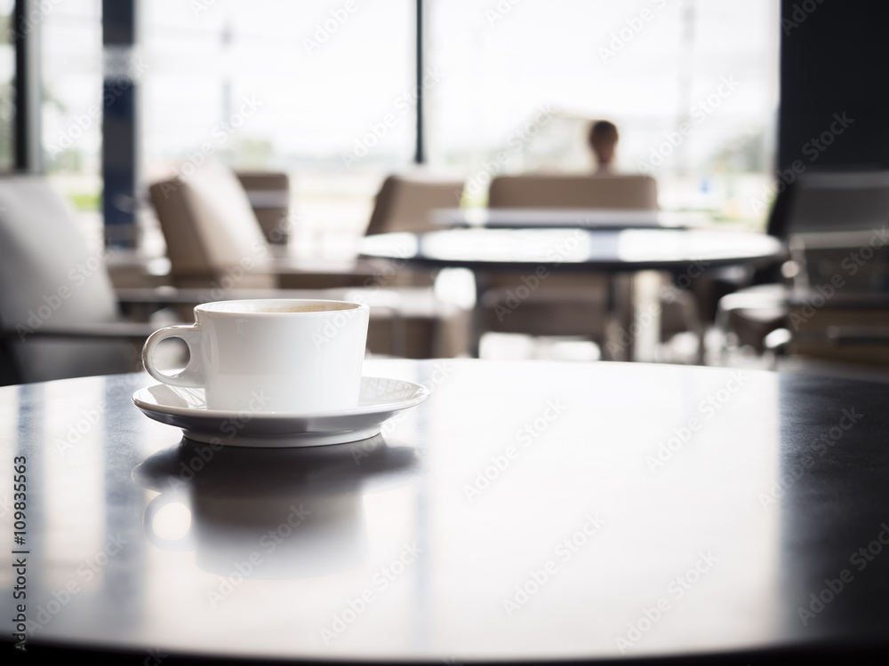 Coffee cup on table with blurred people in Restaurant shop cafe Coffee cup on table with blurred people in Restaurant shop cafe