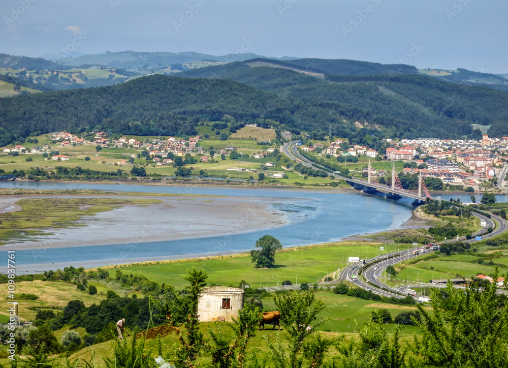 Fototapeta premium Cantabria landscape with field, river and a small town Treto. Spain.
