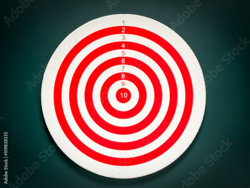 Classic dart target board. Red and white of dartboard on black background.