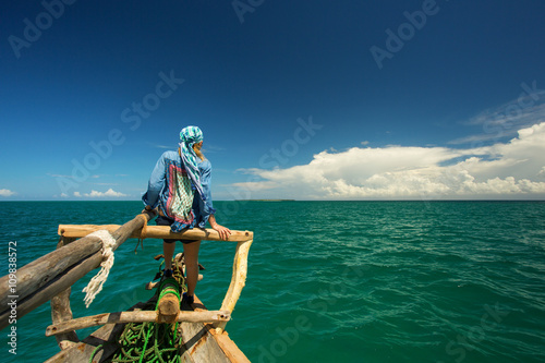 Woman enjoying time on the traditional fisher boat in Zanzibar