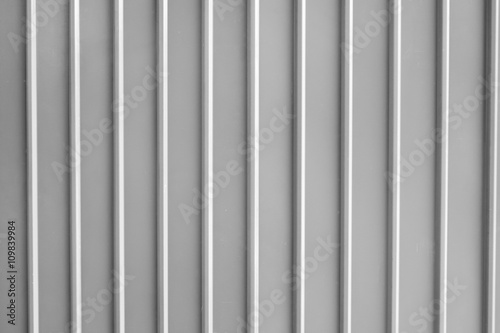 Seamless abstract background grey silver aluminium metal plate texture with vertical lines pattern.