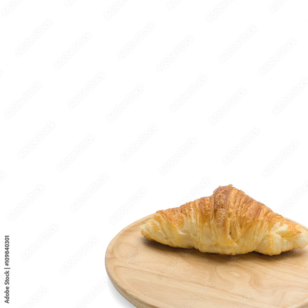 Croissants on wooden plate on white background