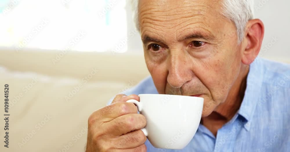 Mature man thinking and holding a cup Mature man thinking and holding a cup