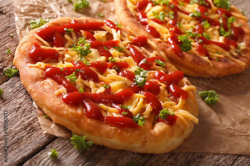 Tasty langos with cheese and ketchup close-up. horizontal 