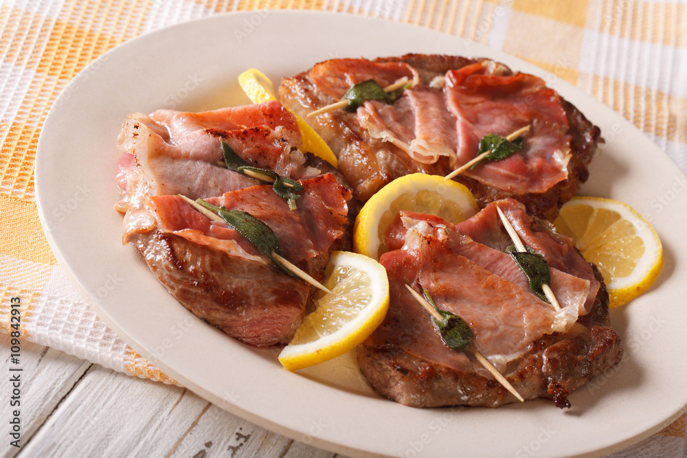 Italian Saltimbocca veal with sage, ham and lemon. horizontal
Italian Saltimbocca veal with sage, ham and lemon. horizontal