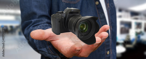 Young man using modern camera