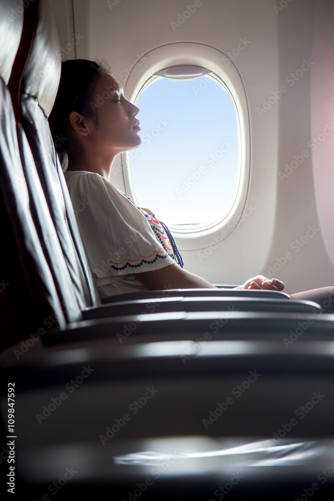 Fototapeta premium woman sleeping in an airplane
