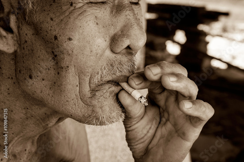 Elderly man smoking ,vintage tone