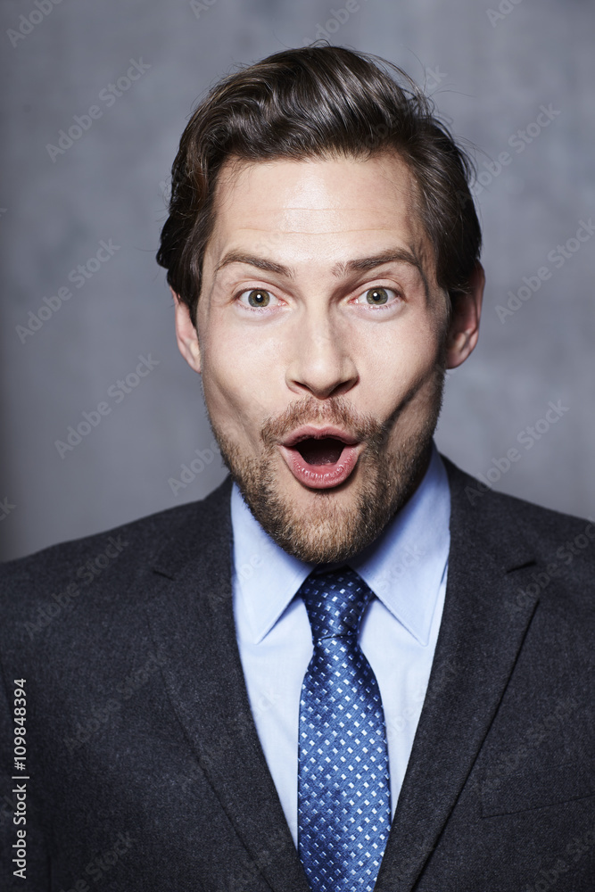 Businessman looking surprised in studio, portrait Businessman looking surprised in studio, portrait
