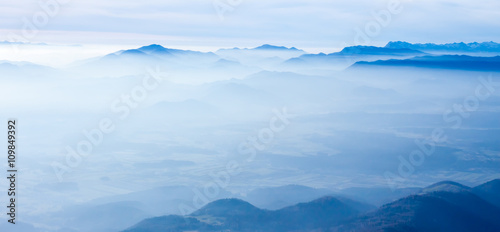 blue foggy mountain landscape © chechotkin