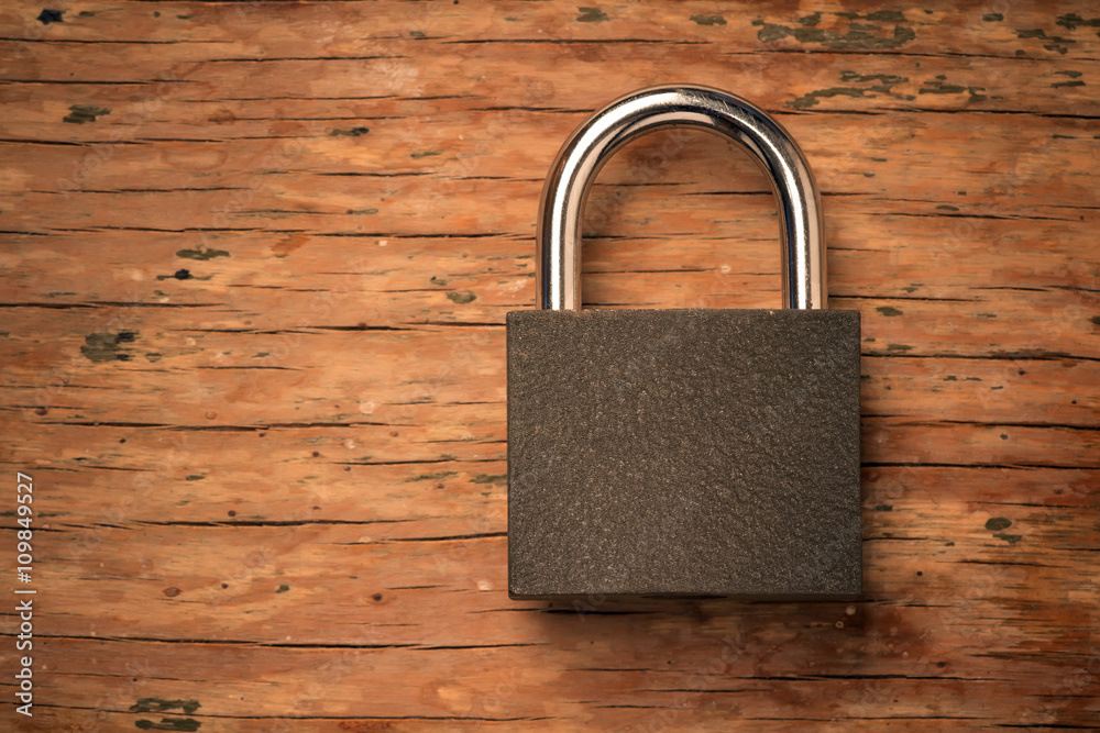 Fototapeta premium padlock on a vintage wooden board