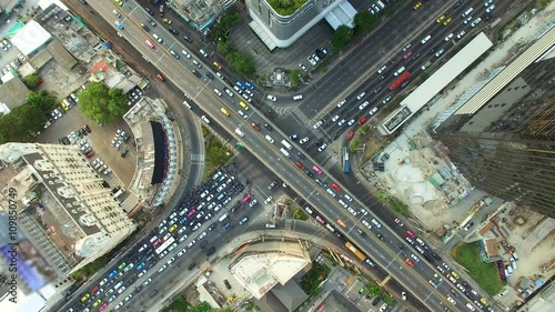 aerial top view of traffic and vehicle car on crossroad or junction in bangkok city area at twilight sunset, 90 degree shot, High quality footage 4K