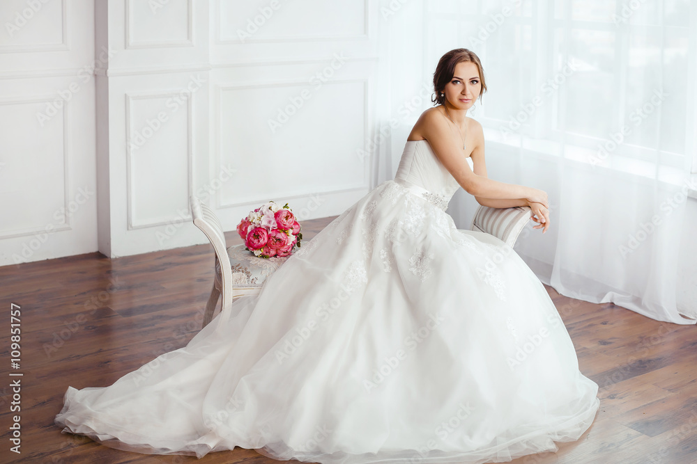 The Bride. Young women with wedding dress in very bright room, The Bride. Young women with wedding dress in very bright room,