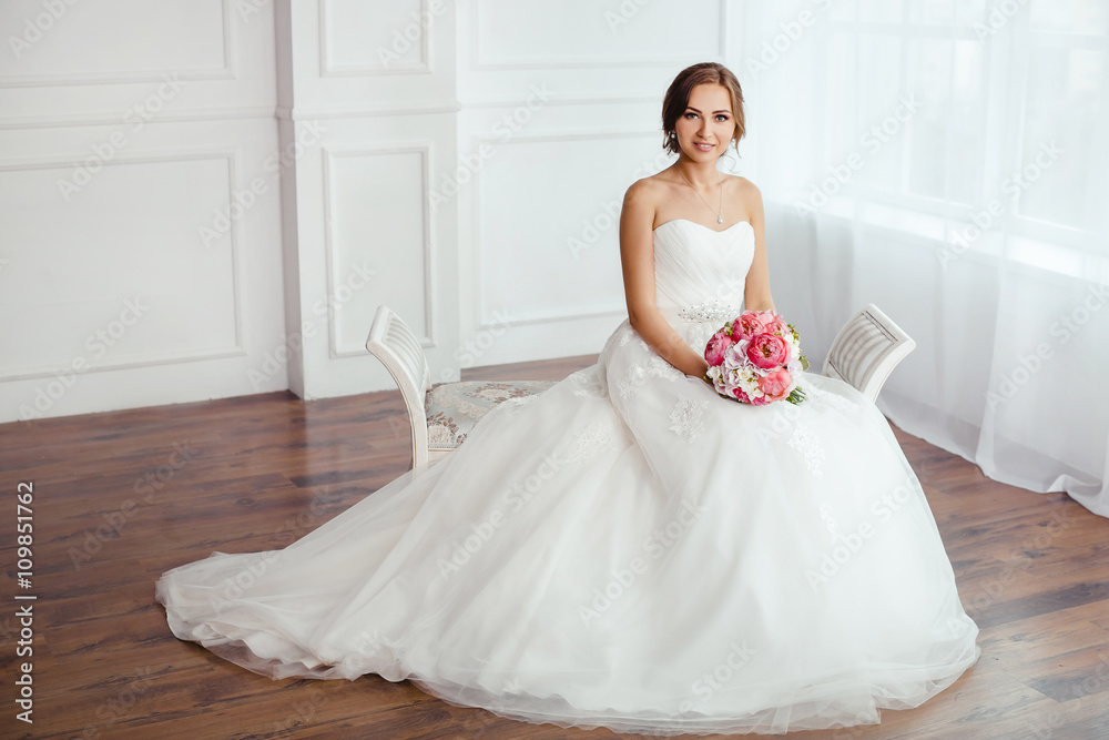 The Bride. Young women with wedding dress in very bright room, The Bride. Young women with wedding dress in very bright room,