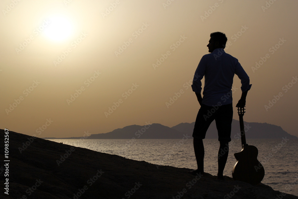 guitarist with guitar and sunrise