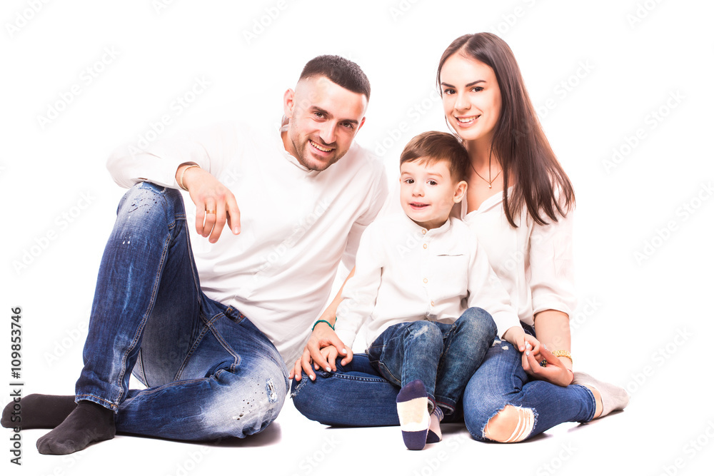 Happy young family with pretty child posing on white background