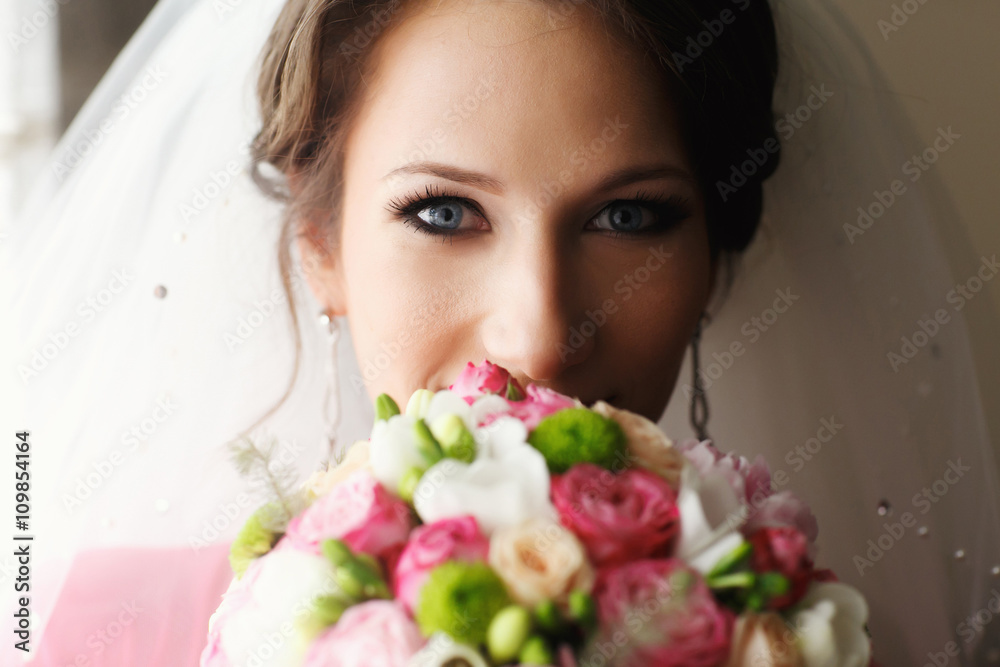 Bride looks over her shoulder and smiles Bride looks over her shoulder and smiles