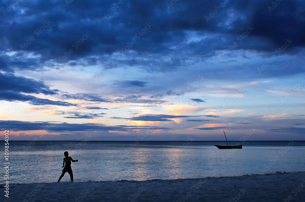 silhouette of child jumping in sunset on the beach silhouette of child jumping in sunset on the beach