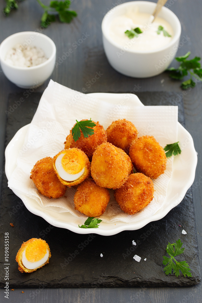Quail eggs, deep fried with white sauce.