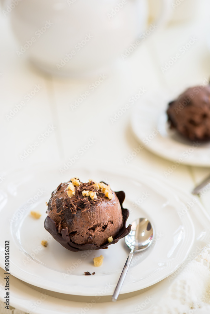 Chocolate Ice Cream Scoop is laying on Chocolate Homemade Bow Chocolate Ice Cream Scoop is laying on Chocolate Homemade Bow