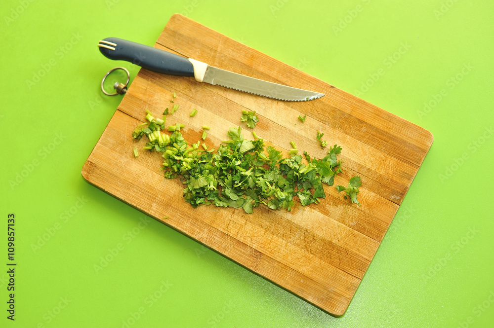Herbs cut on the cutting board with a knife Herbs cut on the cutting board with a knife