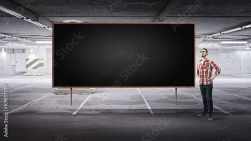Guy in interior near chalkboard © Sergey Nivens