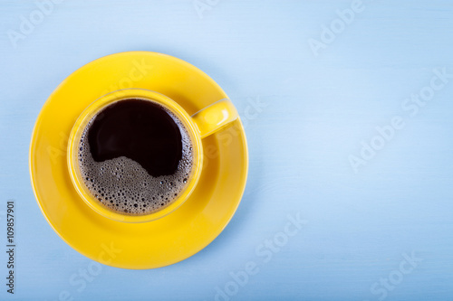 Cup of coffee on blue wooden table